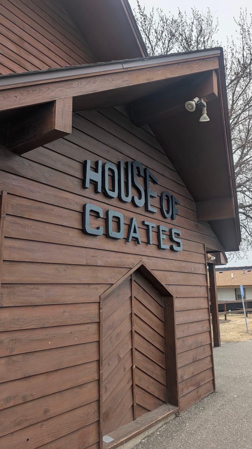 The House of Coates letters on the cedar siding outside the restaurant.